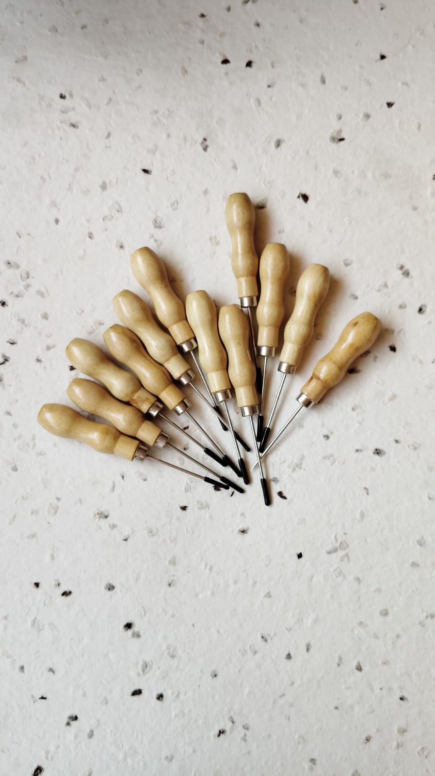 Set of bookbinding awls with turned sheesham-wood handles fanned for display