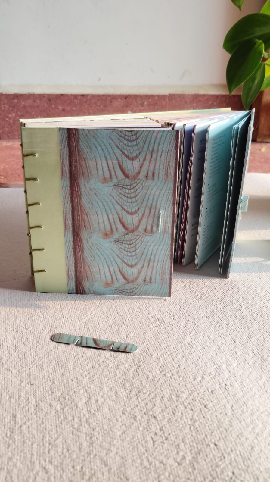 Hand-bound Coptic-stitch journal A5 with marbled cover and exposed binding — Spread & Spine