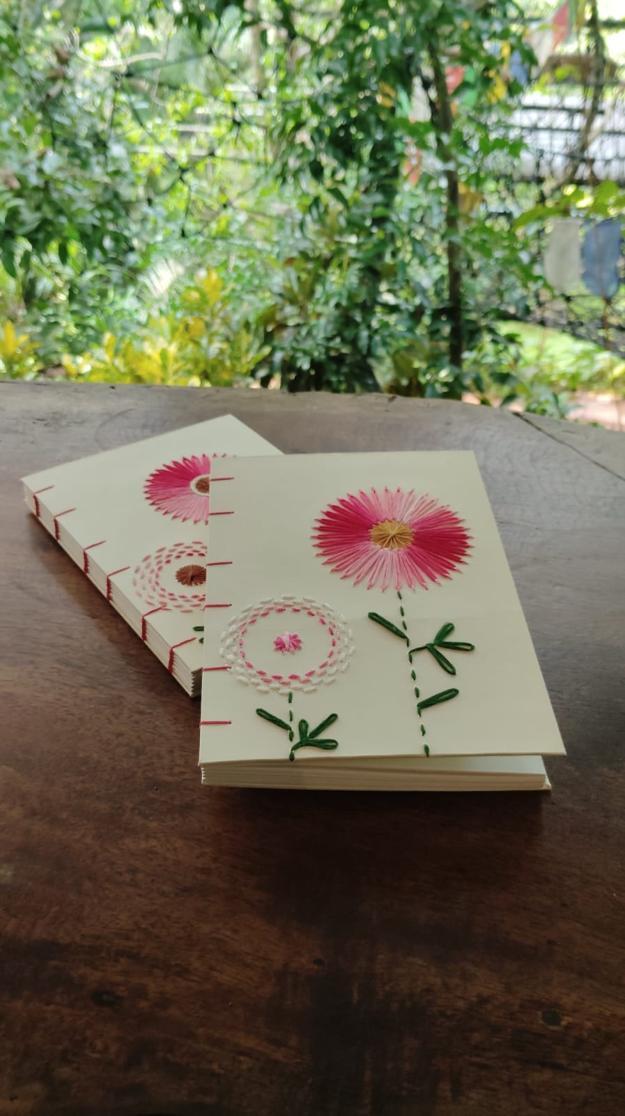 Pair of Coptic-bound journals with hand-embroidered floral covers, made in India
