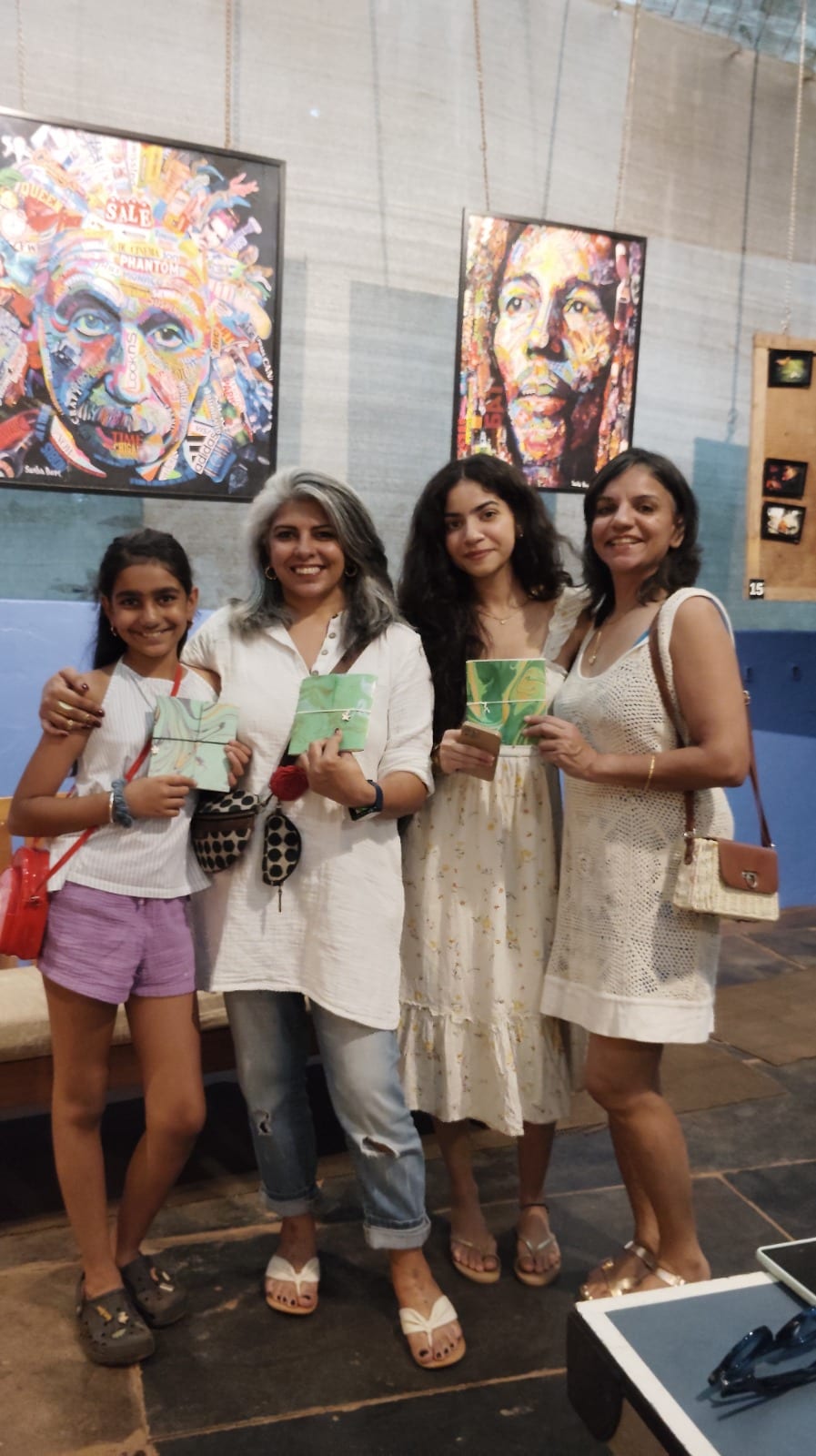 Group of workshop participants holding finished hand-bound journals — Spread & Spine